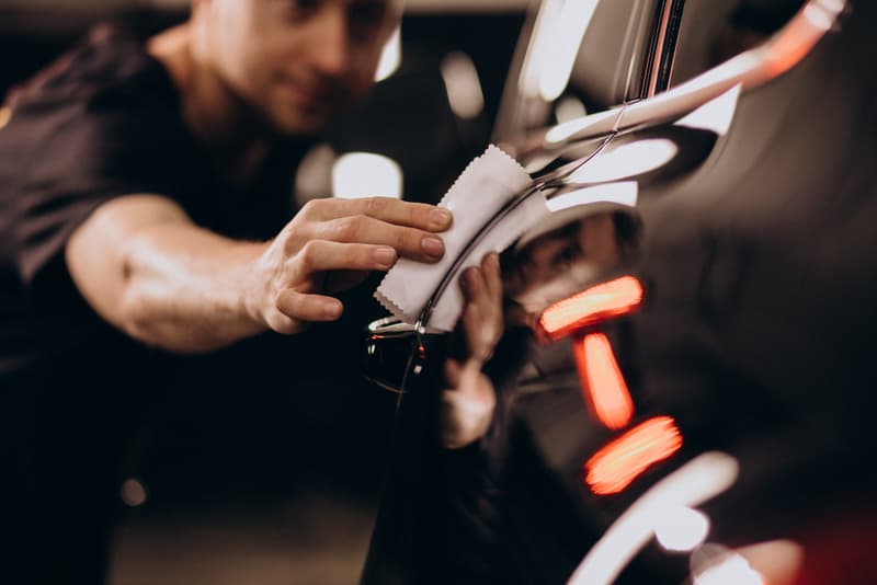Technician applying nano wash to vehicle exterior